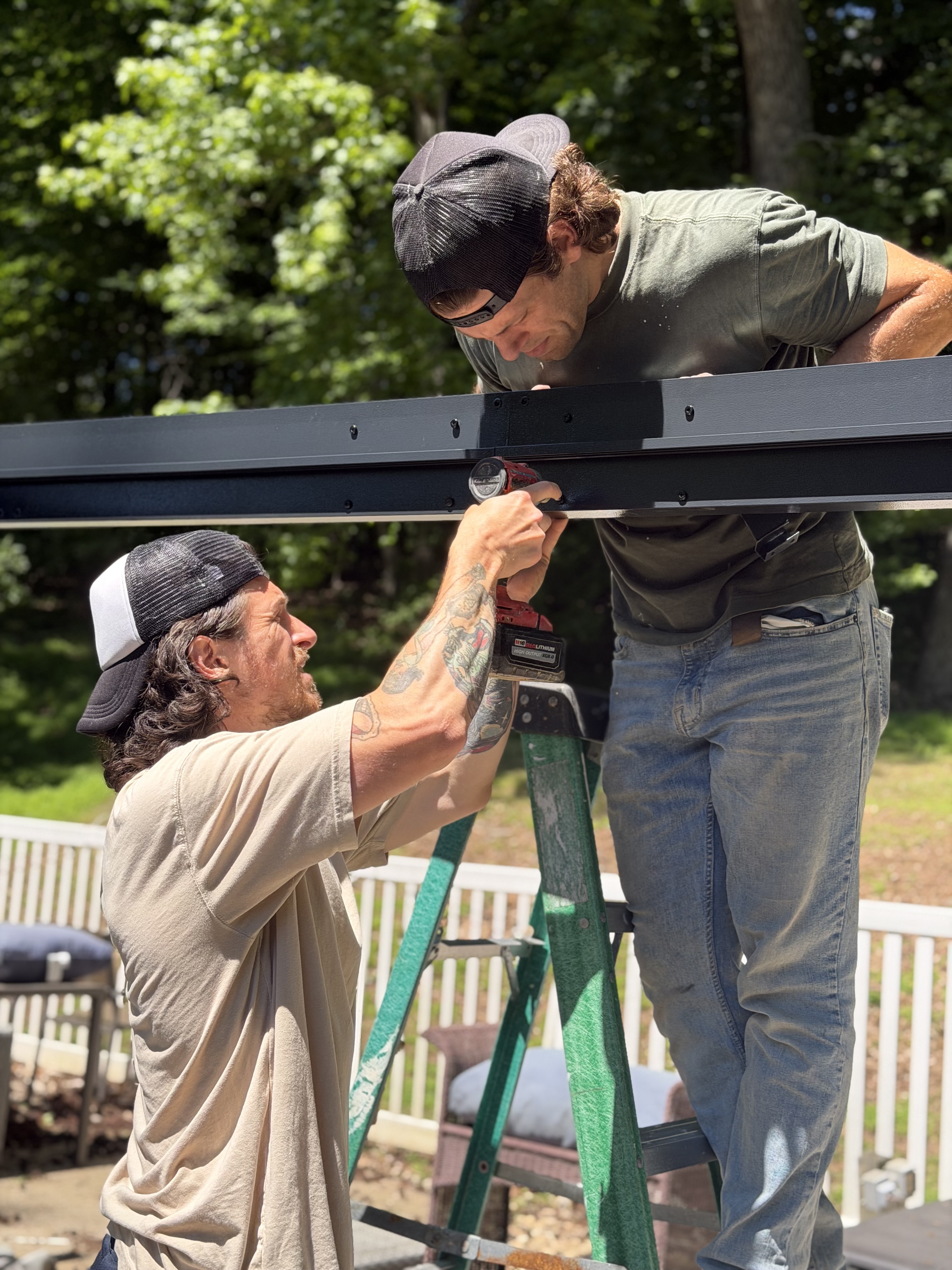 Brandon and his brother on a project — drill, ladder, real work